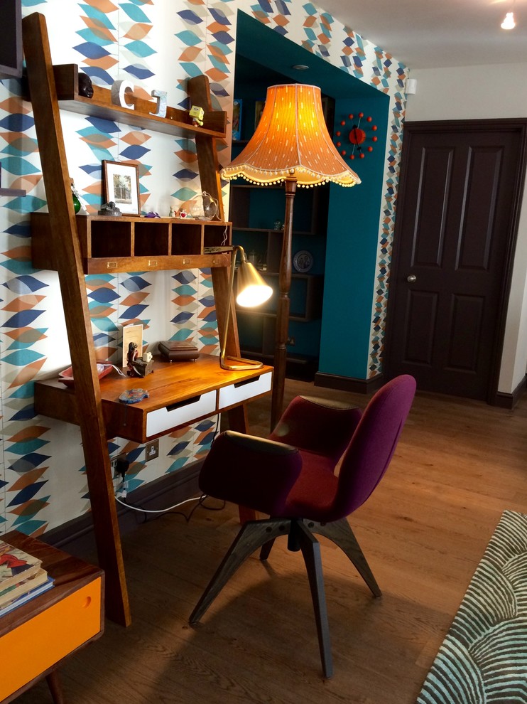 Photo of a large retro study in Other with multi-coloured walls, medium hardwood flooring and a freestanding desk.