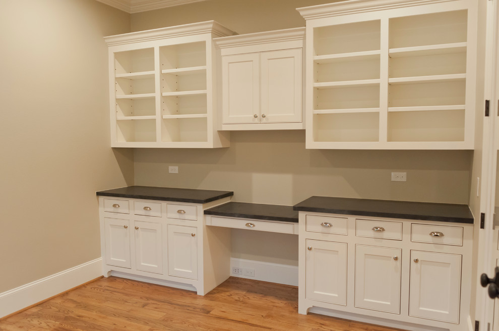 Inspiration for a mid-sized timeless built-in desk medium tone wood floor study room remodel in Houston