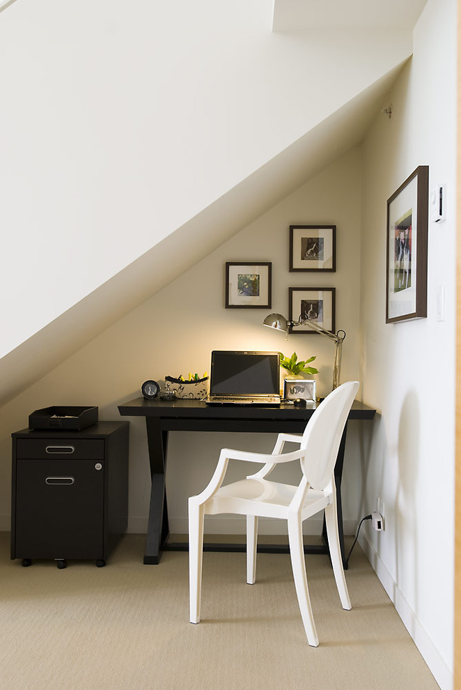 This is an example of a contemporary home office in Vancouver with white walls, carpet and a freestanding desk.