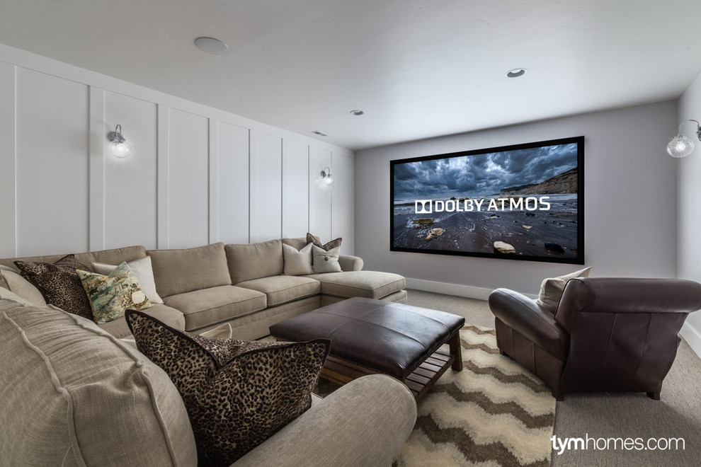 This is an example of a small enclosed home cinema in Salt Lake City with white walls, carpet and a projector screen.
