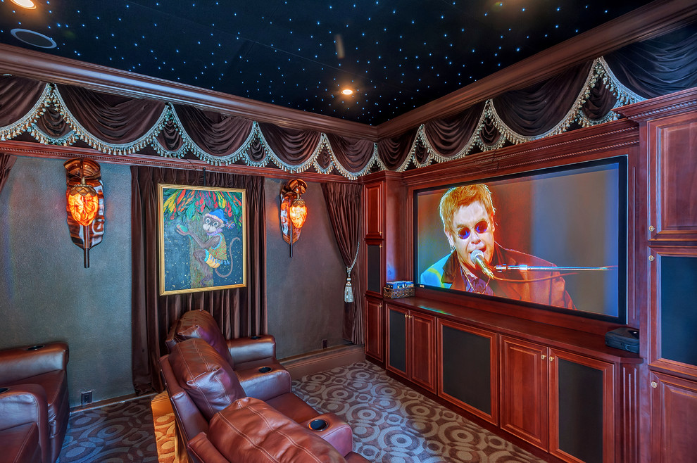 Home theater - mediterranean enclosed carpeted home theater idea in Miami with a media wall