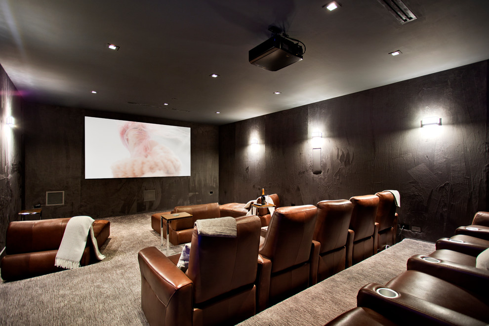 Ejemplo de cine en casa cerrado actual con paredes grises, moqueta, suelo gris y pantalla de proyección