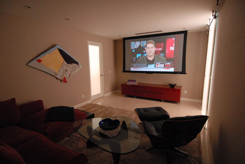 Home theater - small modern enclosed marble floor home theater idea in Los Angeles with a projector screen
