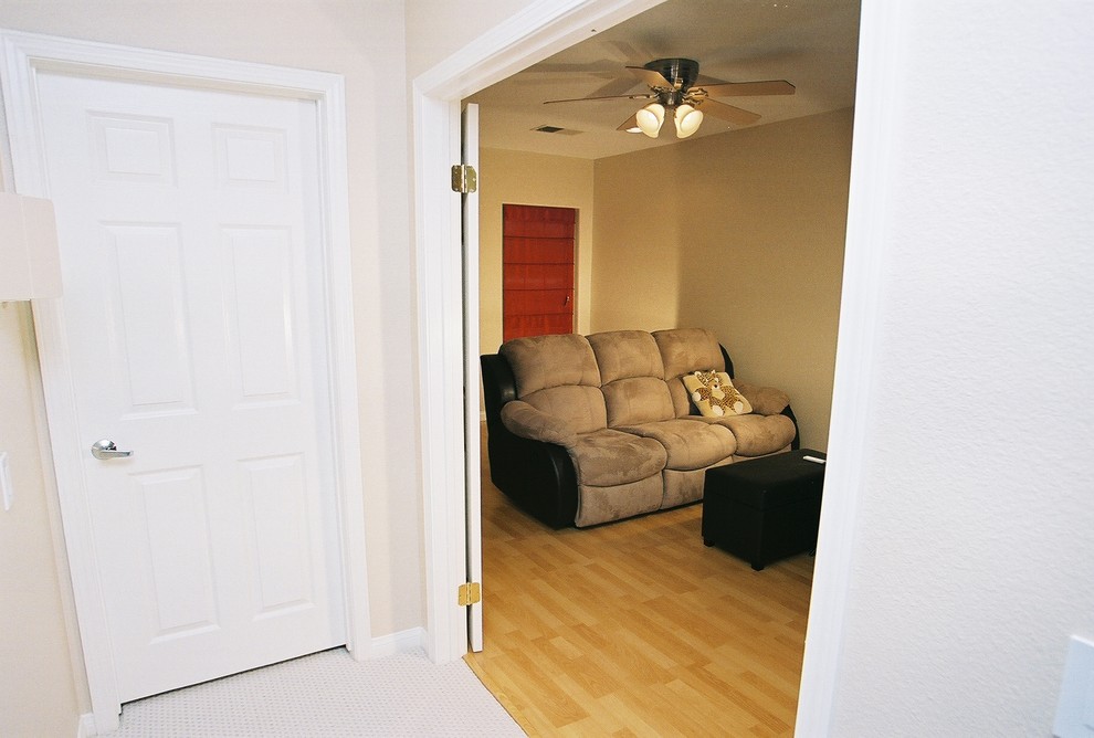 Example of a mid-sized zen enclosed home theater design in Orange County with beige walls