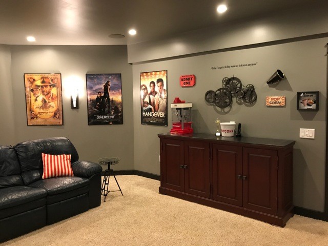 This is an example of a medium sized classic open plan home cinema in New York with beige walls, carpet, a wall mounted tv and beige floors.