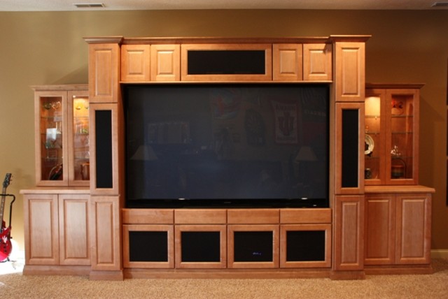 Large elegant enclosed carpeted and brown floor home theater photo in Indianapolis with brown walls and a media wall