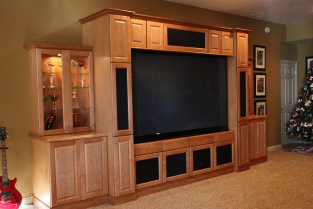 Inspiration for a large traditional enclosed home cinema in Indianapolis with brown walls, carpet, a built-in media unit and brown floors.