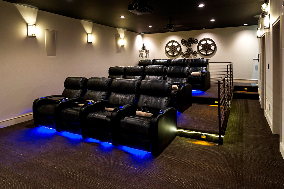 Example of a large 1950s enclosed carpeted and brown floor home theater design in Charlotte with beige walls and a projector screen