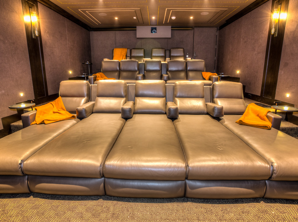 Home theater - large contemporary home theater idea in Los Angeles with brown walls and a media wall