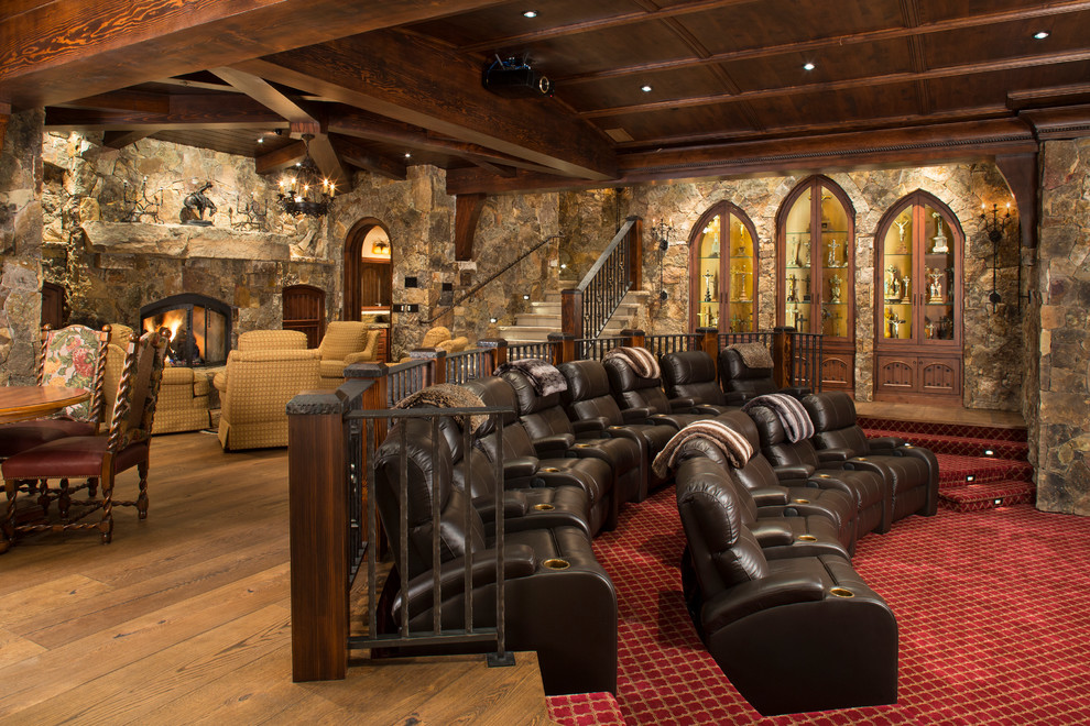 Photo of a large rustic open plan home cinema in Denver with a projector screen.