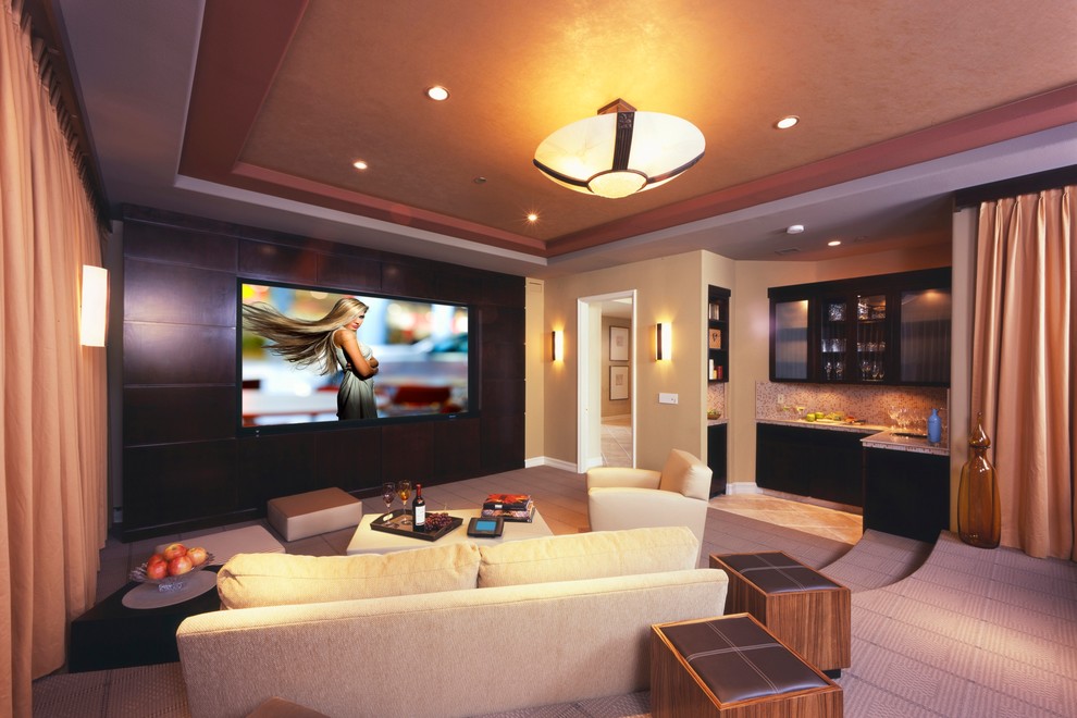 Home theater - contemporary enclosed home theater idea in Los Angeles with a media wall