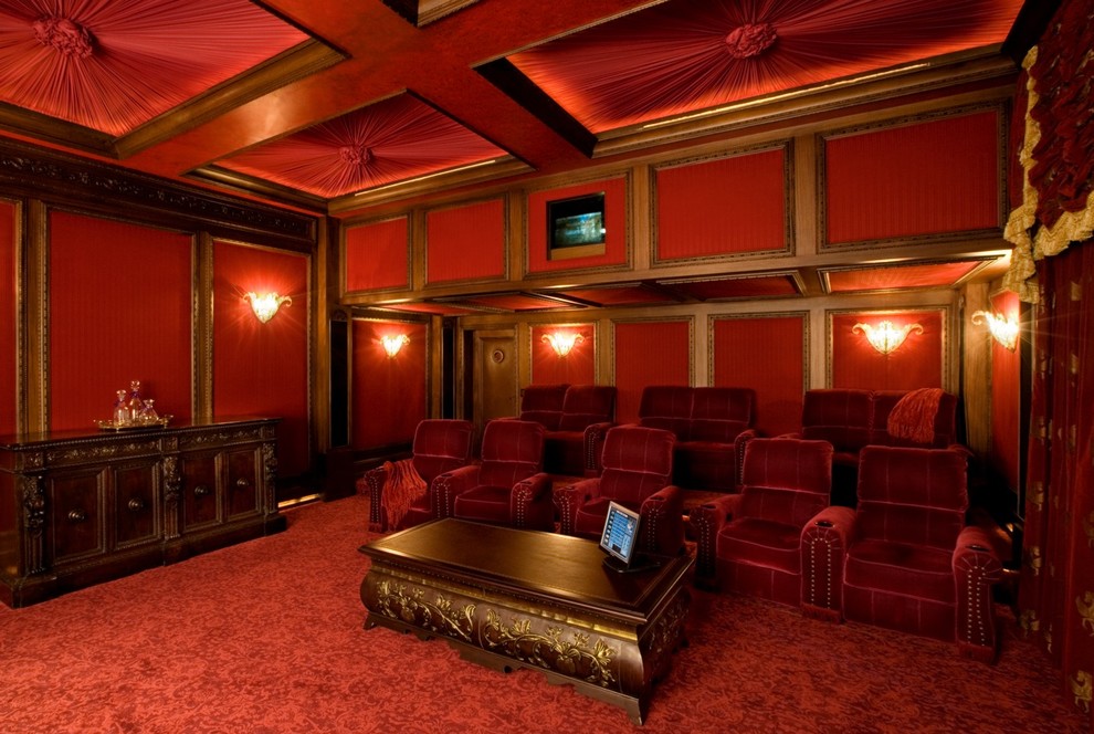 Elegant enclosed home theater photo in Los Angeles with red walls and a projector screen
