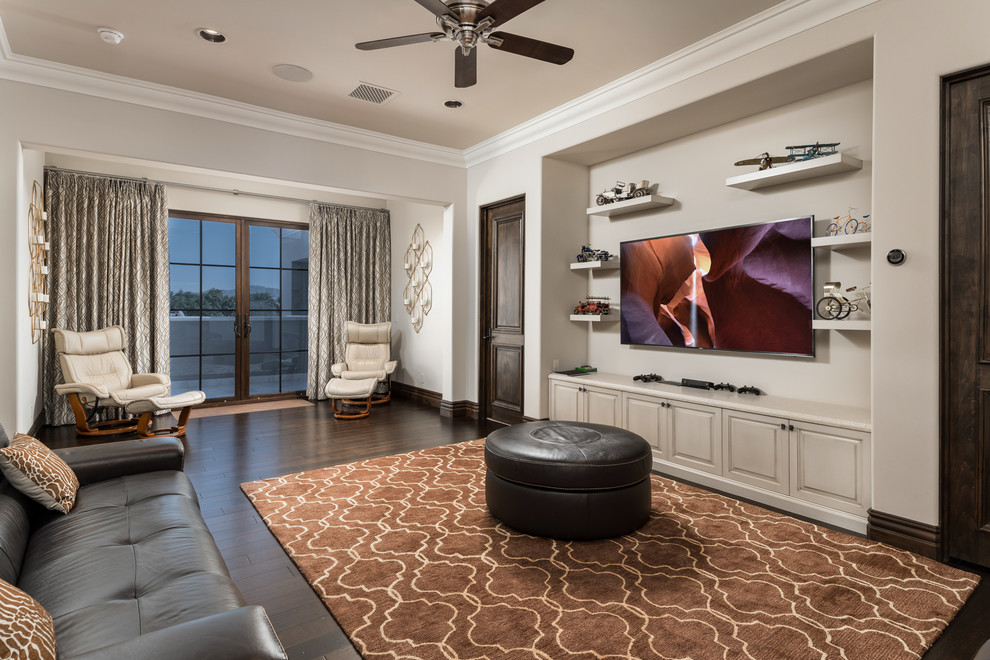 Example of a huge tuscan enclosed carpeted and multicolored floor home theater design in Phoenix with beige walls and a wall-mounted tv