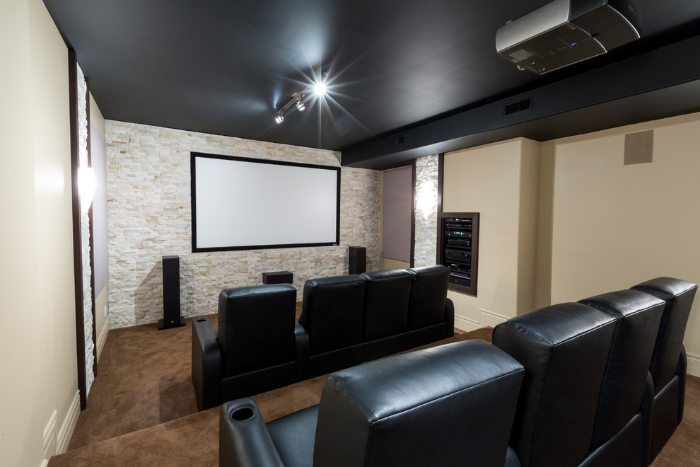 Design ideas for a medium sized traditional enclosed home cinema in Toronto with beige walls, carpet, a projector screen and brown floors.