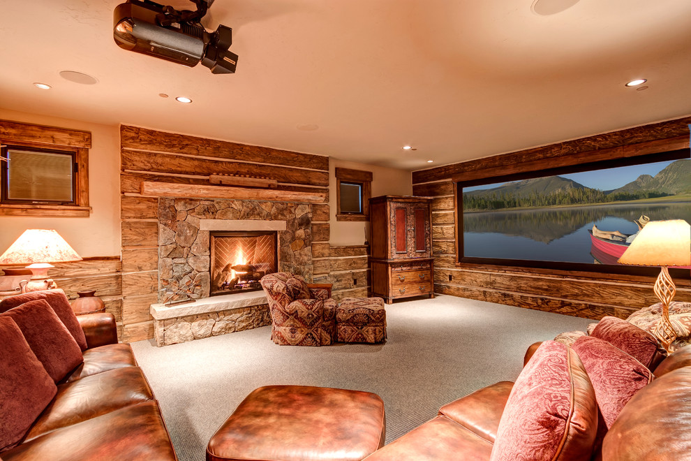 Inspiration for a medium sized rustic enclosed home cinema in Denver with beige walls, carpet, a projector screen and grey floors.