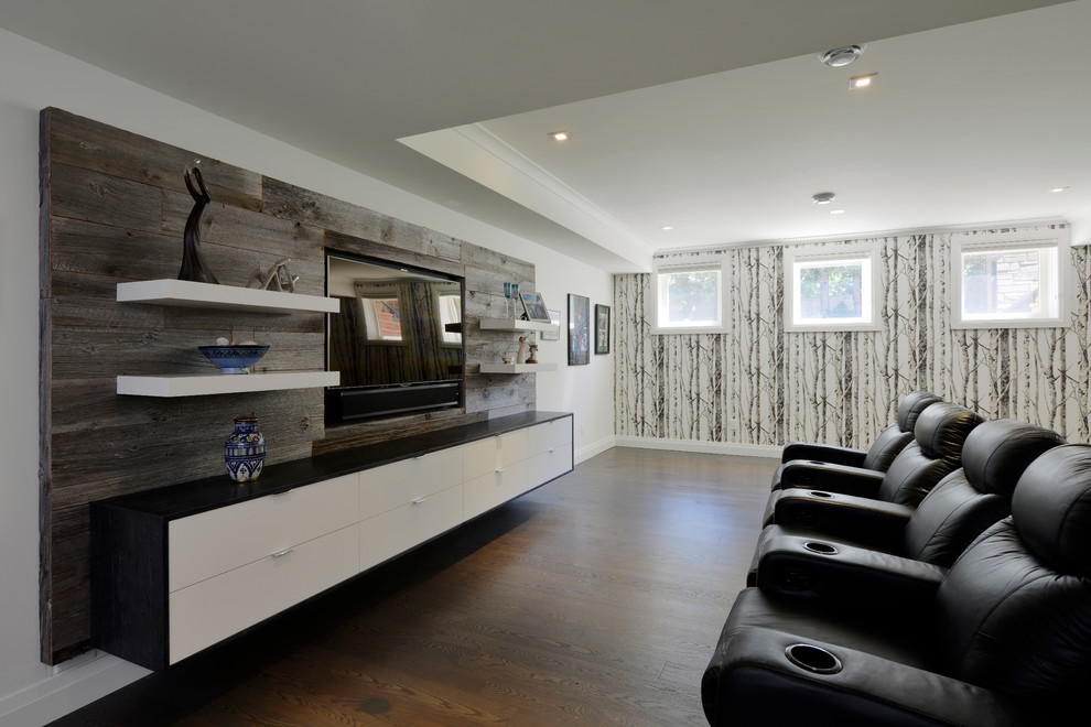 Photo of a large contemporary enclosed home cinema in Toronto with white walls, dark hardwood flooring, a built-in media unit and a feature wall.