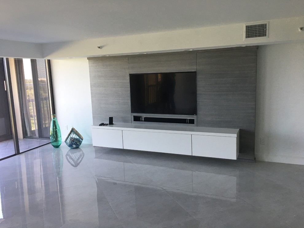 Design ideas for a large contemporary enclosed home cinema in Miami with white walls, marble flooring and a built-in media unit.