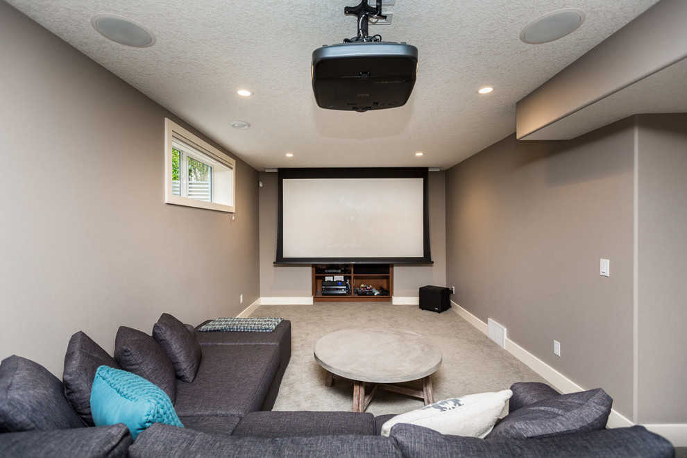 Mid-sized elegant open concept carpeted and gray floor home theater photo in Calgary with gray walls and a projector screen