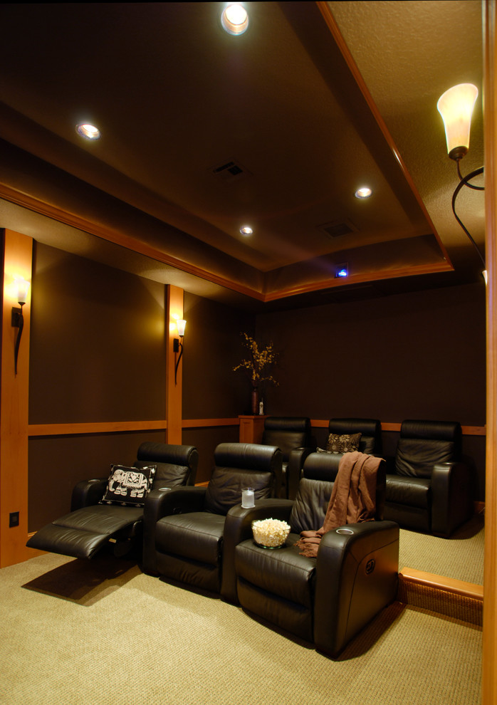 Inspiration for a mid-sized timeless enclosed carpeted home theater remodel in Portland with brown walls and a projector screen
