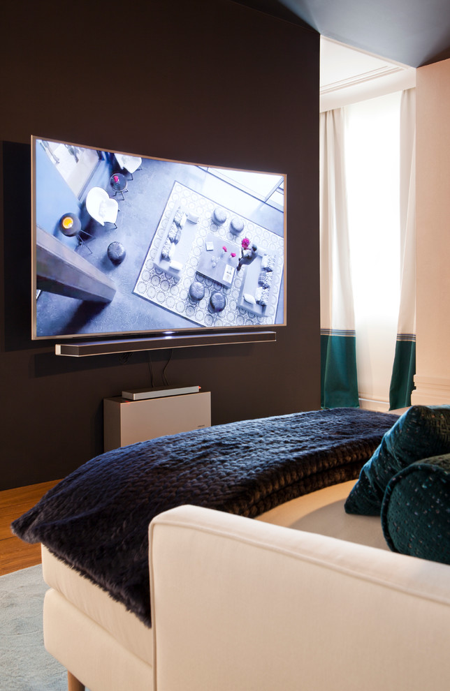 Photo of a medium sized contemporary enclosed home cinema in Madrid with a wall mounted tv.