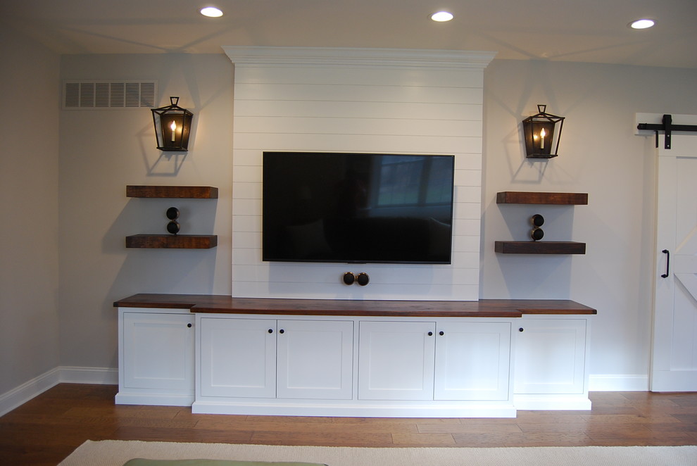 Inspiration for a small farmhouse dark wood floor and brown floor home theater remodel in Philadelphia with gray walls and a wall-mounted tv