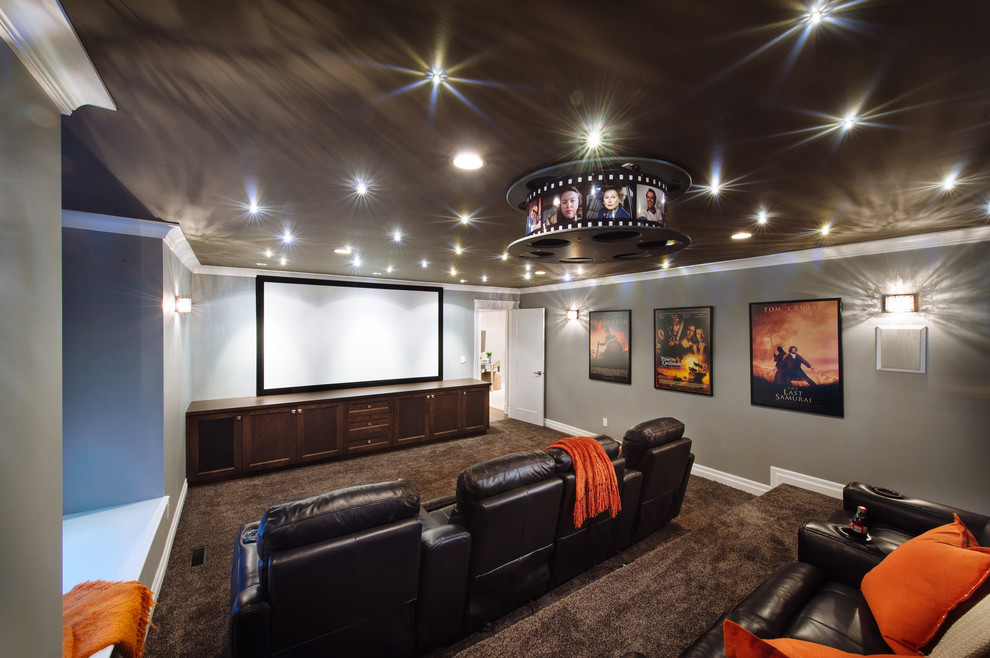This is an example of a large classic enclosed home cinema in Vancouver with grey walls, carpet and a projector screen.
