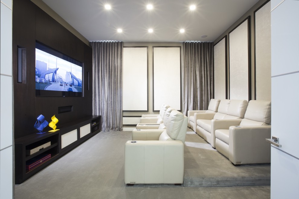 Home theater - contemporary enclosed home theater idea in Miami with beige walls