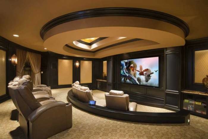 Huge trendy enclosed carpeted home theater photo in Atlanta with beige walls and a media wall