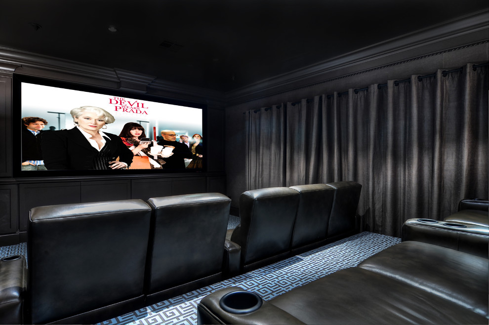 На фото: большой изолированный домашний кинотеатр в стиле неоклассика (современная классика) с черными стенами, ковровым покрытием, проектором и синим полом с