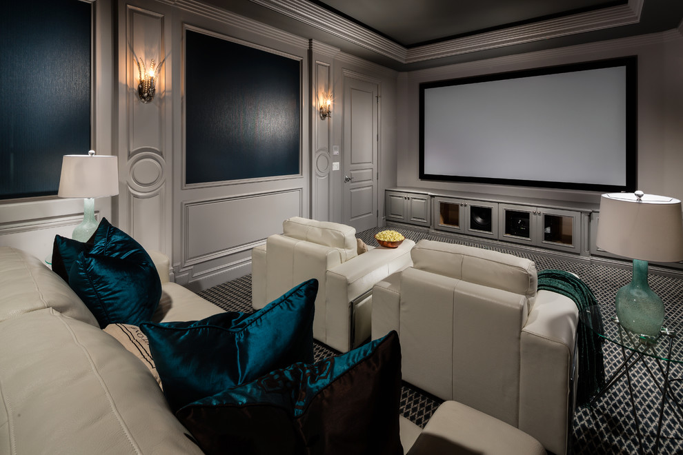 На фото: домашний кинотеатр в стиле неоклассика (современная классика) с серыми стенами, ковровым покрытием, проектором и разноцветным полом с