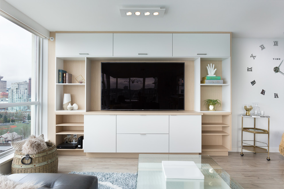 Medium sized modern enclosed home cinema in Vancouver with white walls, laminate floors, a built-in media unit and beige floors.