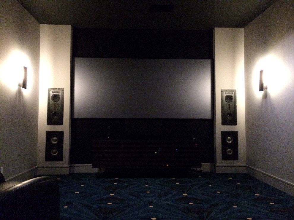 Mid-sized trendy carpeted home theater photo in Los Angeles with black walls and a projector screen