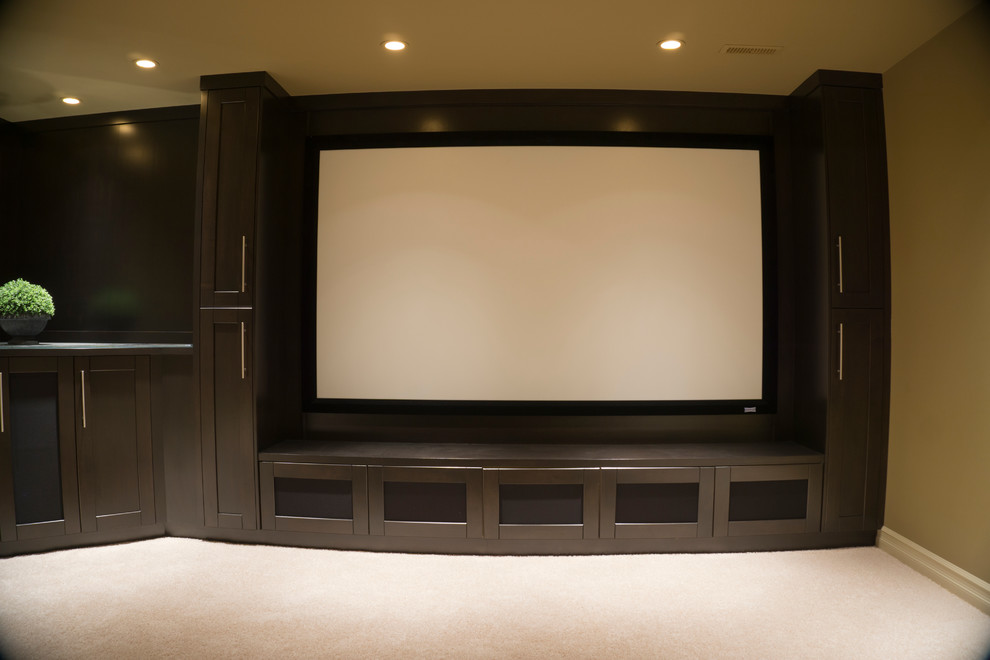 Photo of a medium sized modern enclosed home cinema in Calgary with brown walls, carpet, a projector screen and beige floors.