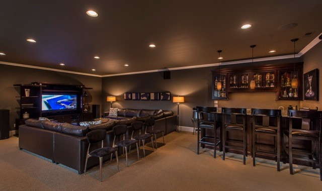 Large mediterranean open plan home cinema in Seattle with beige walls, carpet, a built-in media unit and beige floors.