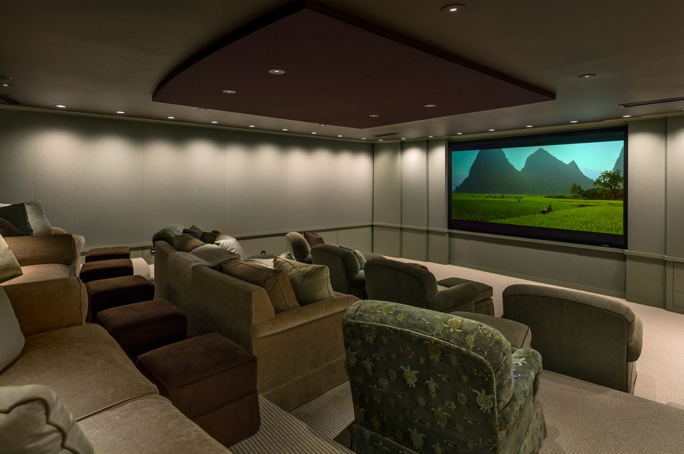 Expansive traditional enclosed home cinema in Boston with carpet and a projector screen.