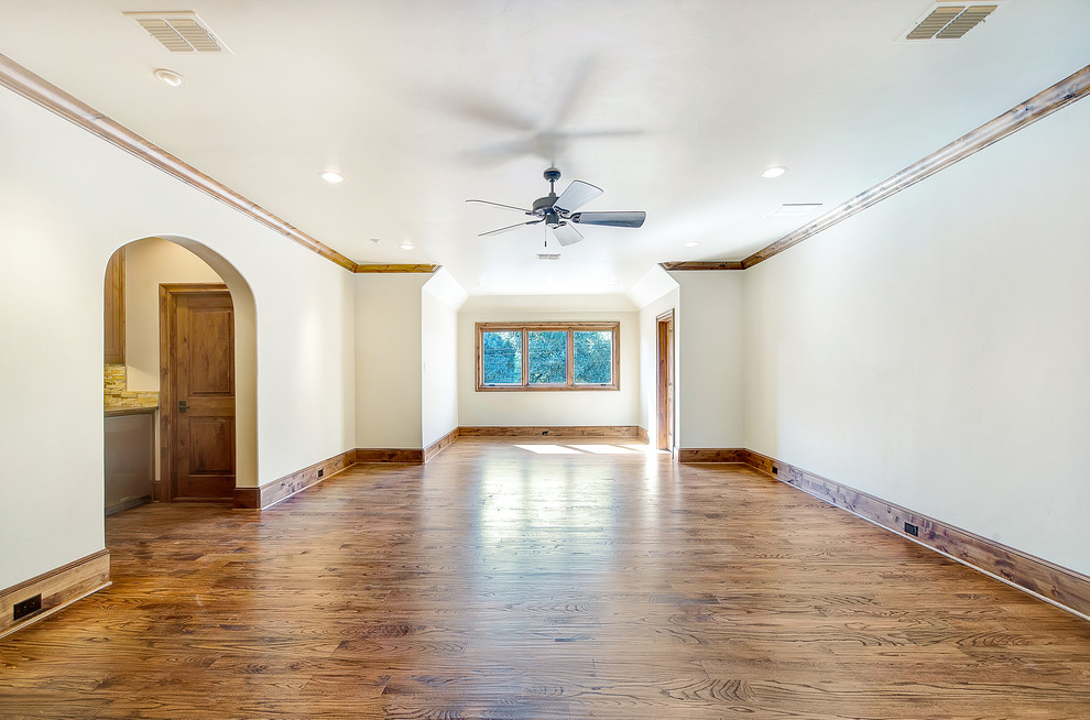 Example of a mountain style medium tone wood floor home theater design in Dallas with white walls