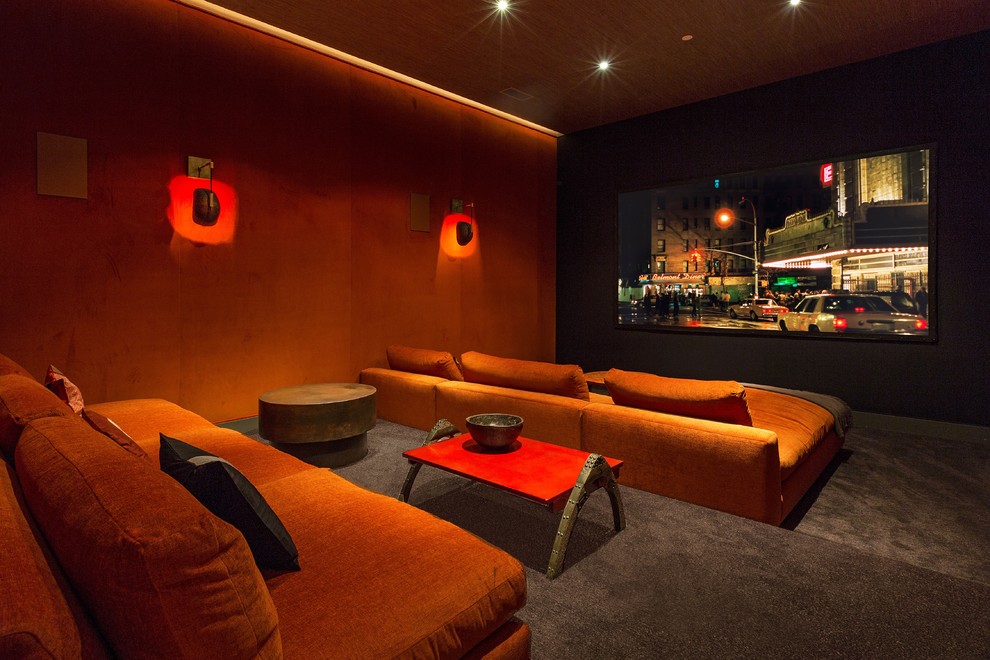 Large trendy enclosed carpeted home theater photo in Los Angeles with a projector screen