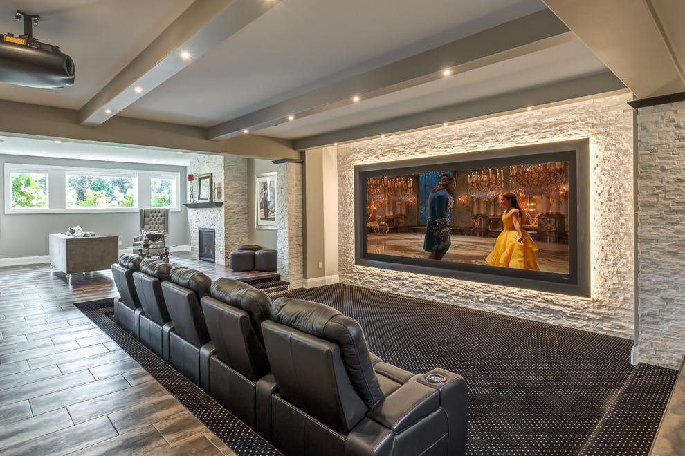 Traditional open plan home cinema in Other with carpet, a projector screen, multi-coloured floors and a feature wall.