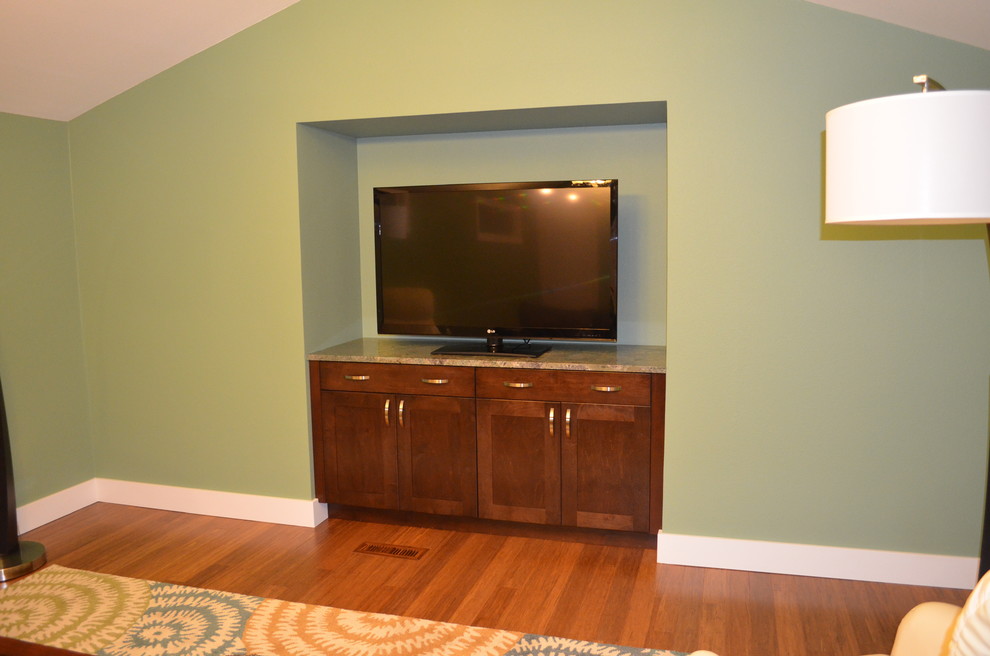 Photo of a large traditional open plan home cinema in Seattle with green walls, bamboo flooring and a built-in media unit.