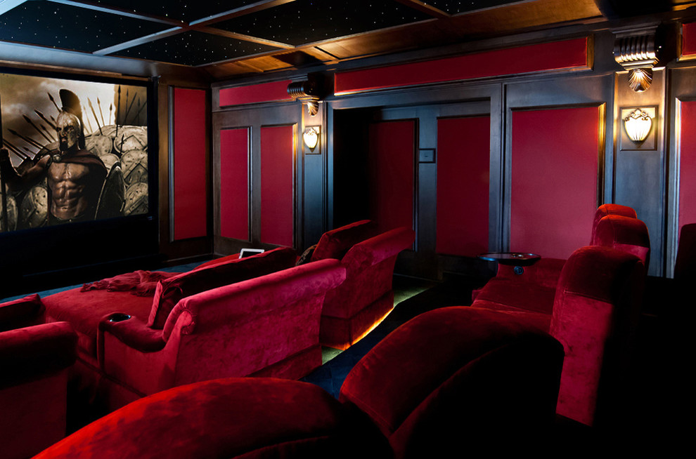 This is an example of a medium sized traditional enclosed home cinema in Vancouver with red walls, carpet and a projector screen.