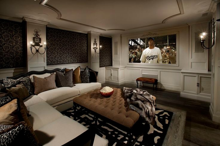 This is an example of an expansive traditional open plan home cinema in Phoenix with beige walls, medium hardwood flooring and a wall mounted tv.