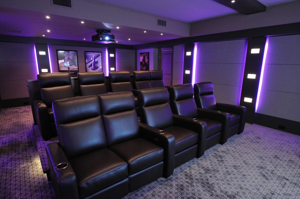 Photo of a large modern enclosed home cinema in New Orleans with grey walls, carpet, a projector screen and grey floors.