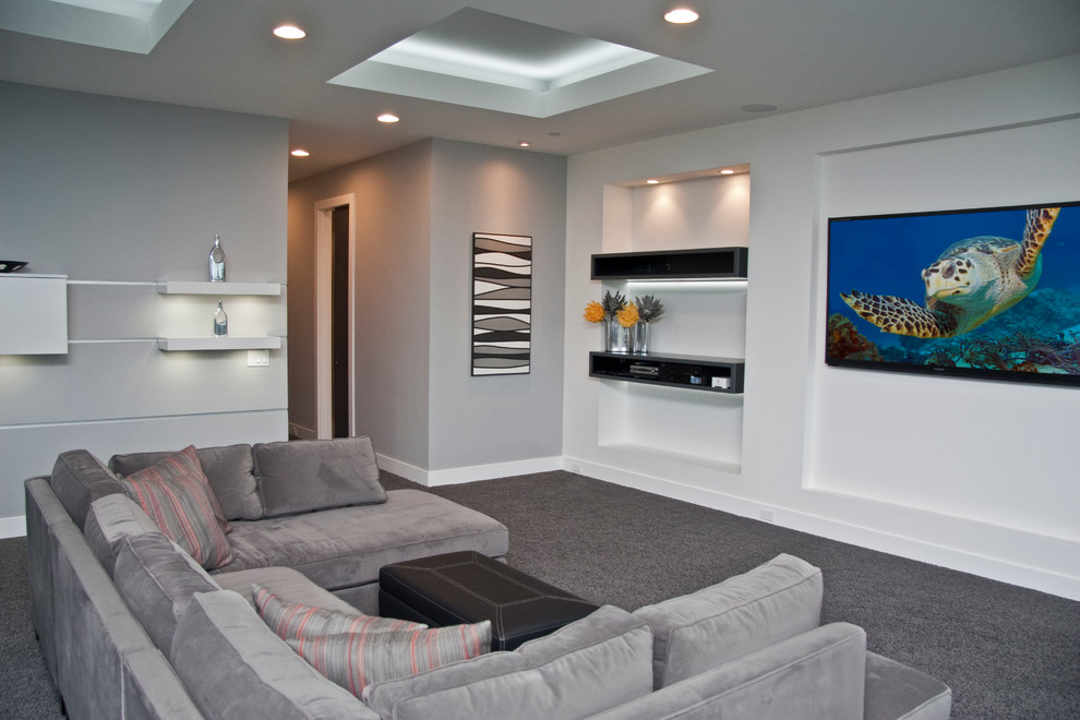 Design ideas for a large contemporary open plan home cinema in Grand Rapids with white walls and a wall mounted tv.