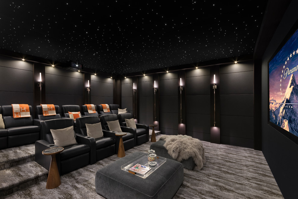 Trendy enclosed carpeted and gray floor home theater photo in Orange County with black walls