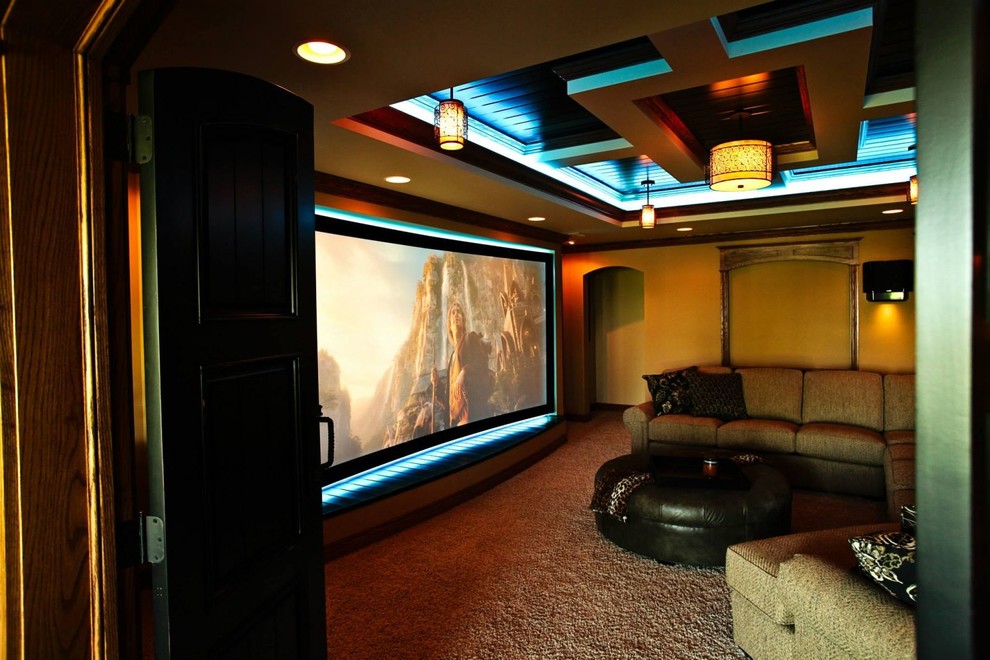 Home theater - large traditional enclosed home theater idea in Grand Rapids with beige walls and a projector screen