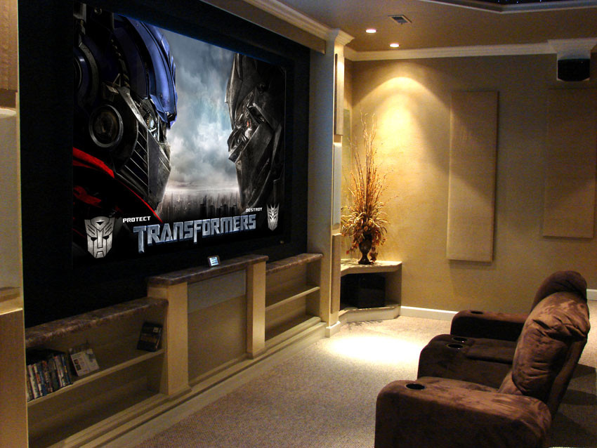 Home theater - carpeted home theater idea in Other with beige walls and a projector screen