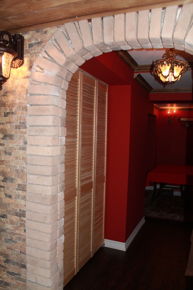 Photo of a medium sized mediterranean enclosed home cinema in Toronto with red walls and dark hardwood flooring.