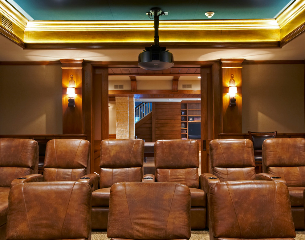 Expansive traditional enclosed home cinema in New York with beige walls, a projector screen and beige floors.