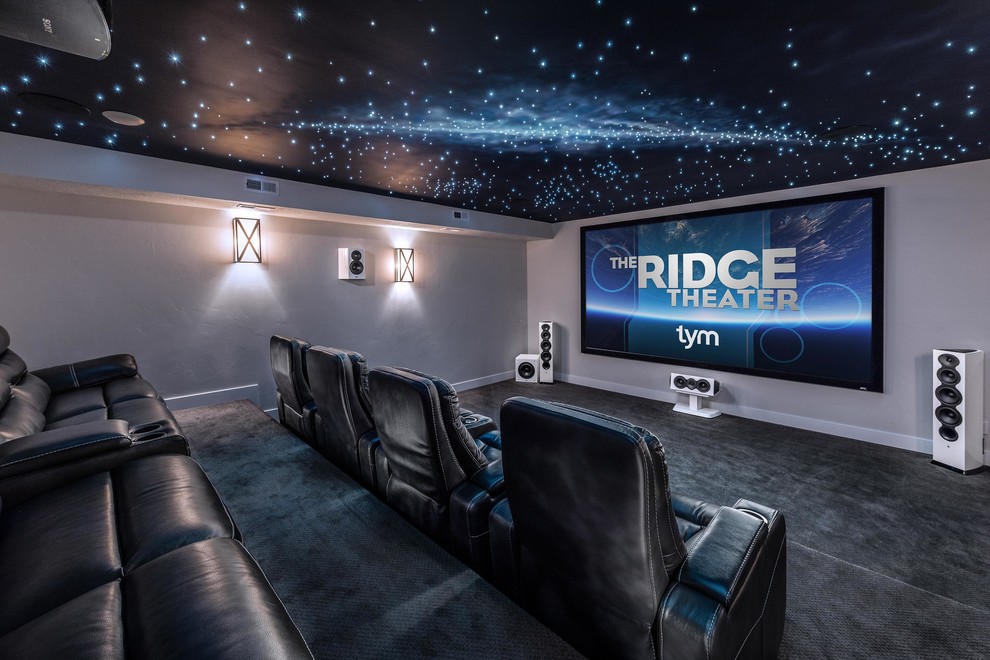 Large contemporary enclosed home cinema in Salt Lake City with carpet, a projector screen, grey floors and grey walls.