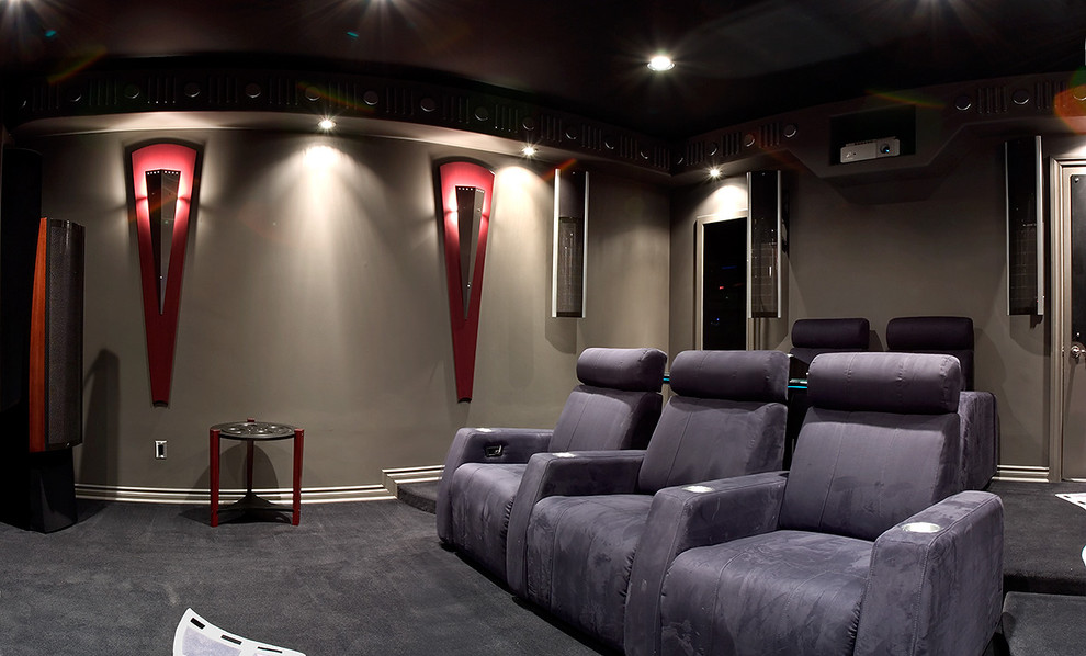 Idée de décoration pour une grande salle de cinéma design fermée avec un mur gris, moquette et un écran de projection.